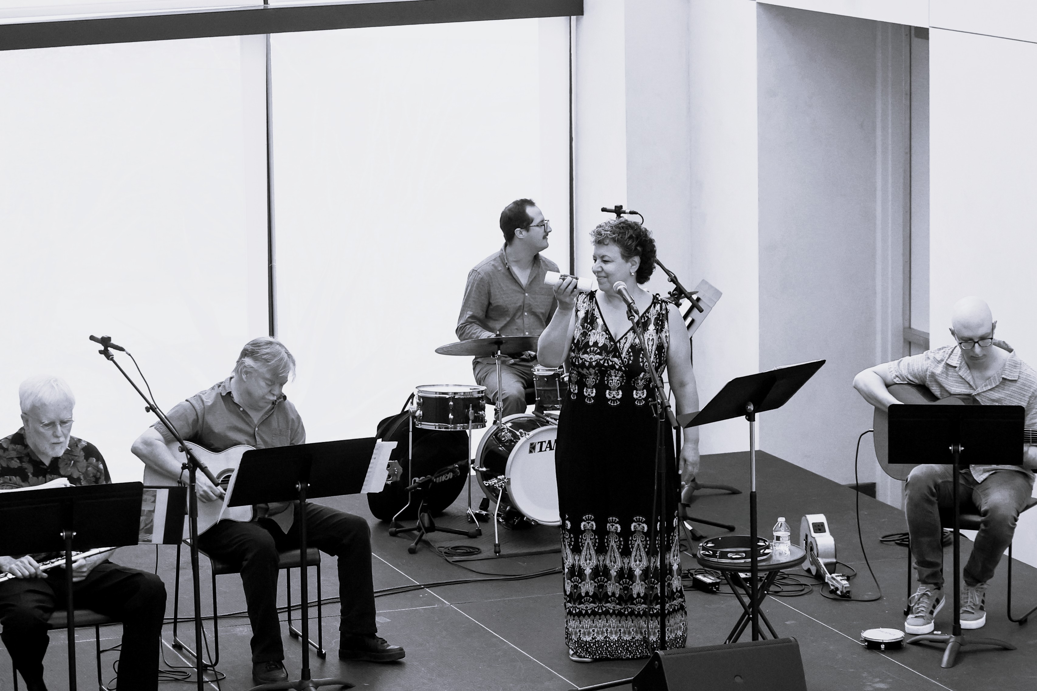 Five members of Bossa Brazil performing on a small stage.